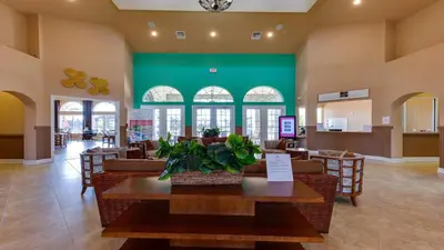 a restaurant with a table and chairs and a green wall at Spacious 12-Bed Villa with Pool & Resort Amenities in Kissimmee