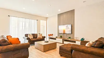a living room with two couches and a table at Spacious 12-Bed Villa with Pool & Resort Amenities in Kissimmee