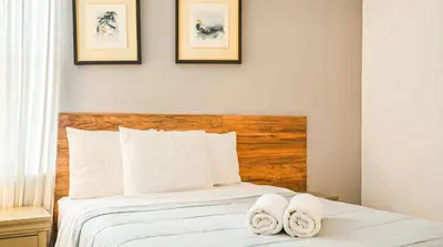 a bedroom with a bed with two towels on it at Spacious 12-Bed Villa with Pool & Resort Amenities in Kissimmee