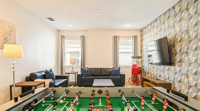 a living room with a couch and a table at Spacious 12-Bed Villa with Pool & Resort Amenities in Kissimmee