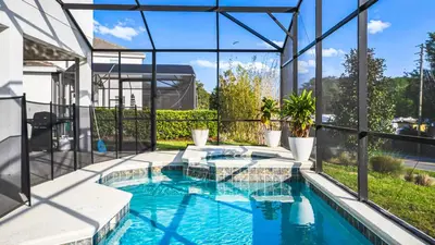 a swimming pool with a view of a house at Spacious 12-Bed Villa with Pool & Resort Amenities in Kissimmee