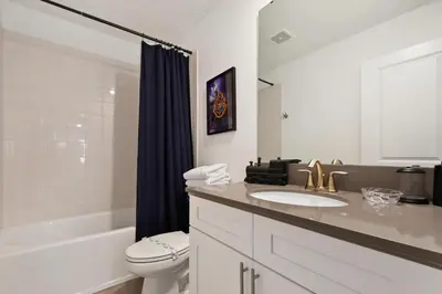 a bathroom with a sink and a toilet and a shower at Lakeview Villa Near Disney with Pool & Resort in Kissimmee
