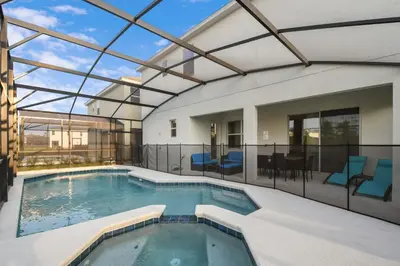 an indoor swimming pool with a glass roof at Lakeview Spacious 12br Themed Home Game/Pool/Spa in Kissimmee