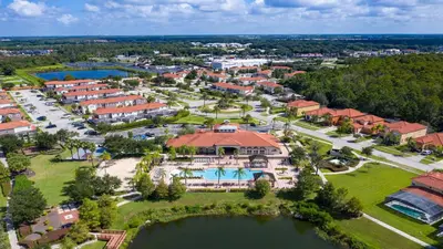 an aerial view of a resort with a large building at Lakeview Spacious 12br Themed Home Game/Pool/Spa in Kissimmee