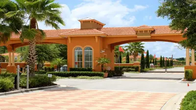an orange building with an arch in a courtyard at Lakeview Spacious 12br Themed Home Game/Pool/Spa in Kissimmee