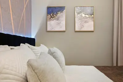 a bedroom with three pictures on the wall at Lakeview Spacious 12br Themed Home Game/Pool/Spa in Kissimmee