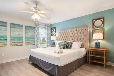 a bedroom with a large bed and a ceiling fan at Lakeview 6BR Cozy Home Pool/SPA,Steps to Waterpark in Kissimmee