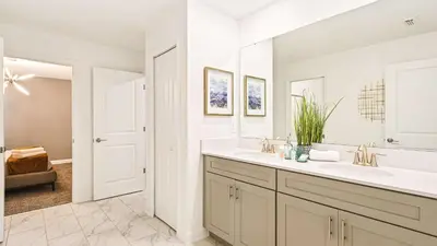 a white bathroom with a sink and a mirror at Lakeview 10BR Home Pool/SPA Game Room Disney Theme in Kissimmee