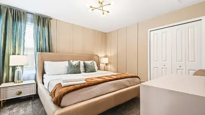 a bedroom with a bed and a window at Lakeview 10BR Home Pool/SPA Game Room Disney Theme in Kissimmee