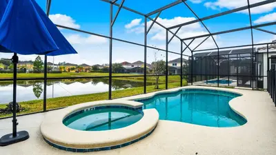a swimming pool in a building with an umbrella at Veranda Palms Lakeview 6br Villa Pool Spa, Disney in Kissimmee