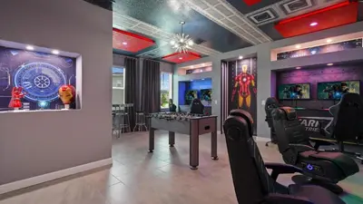 a gym with a game room with a table and chairs at Star Wars Disney Themed 10BR Villa Pool/Spa/Game in Kissimmee