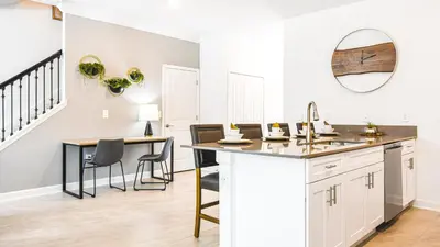 a kitchen with a table and chairs and a sink at Storey Lake 5br Family Townhome w Pool Near Disney in Kissimmee