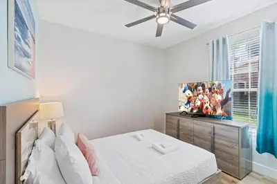 a bedroom with a bed and a ceiling fan at The Epic London Vista Cay Orlando Next to the club in Orlando