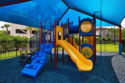 a playground with a slide in a park at The Epic London Vista Cay Orlando Next to the club in Orlando