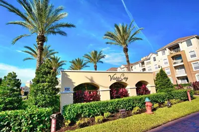 a hotel with palm trees in front of a building at The Epic London Vista Cay Orlando Next to the club in Orlando