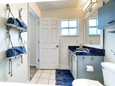 a bathroom with a sink and a toilet and a mirror at 3 Bedroom Townhome Close to Disney in Kissimmee