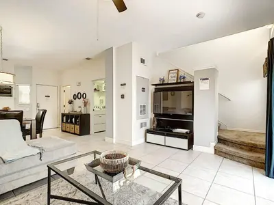 a living room with a couch and a table at 3 Bedroom Townhome Close to Disney in Kissimmee