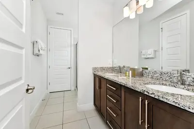 a bathroom with two sinks and a large mirror at Elegant Home With Private Pool, Waterpark & Resort Access Near Disney At Encore Resort - 7610Wi in Kissimmee