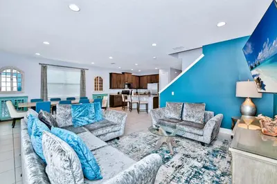 a living room with blue walls and couches at Elegant Home With Private Pool, Waterpark & Resort Access Near Disney At Encore Resort - 7610Wi in Kissimmee
