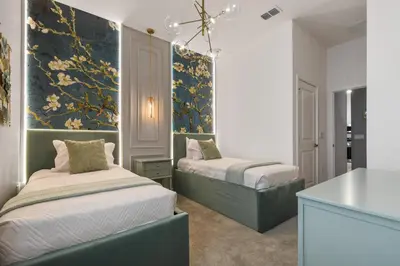 a bedroom with two beds and a counter in it at Game Room 12BR Kids World Pool Spa Near Disney in Kissimmee