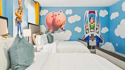 a bedroom with two beds and a pink pig mural at Storey Lake 9BR Lakeview Home Pool/SPA/Game Disney in Kissimmee