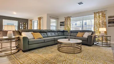 a living room with a couch and a table at Cozy Home Storey Lake Resort Pool Spa Near Disney in Kissimmee