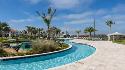 a swimming pool at a resort with palm trees at Family Oasis: Pool, Themed Rooms & Resort Access in Kissimmee