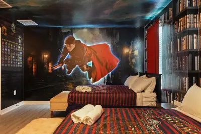 a bedroom with a superhero painting on the wall at Family Oasis: Pool, Themed Rooms & Resort Access in Kissimmee