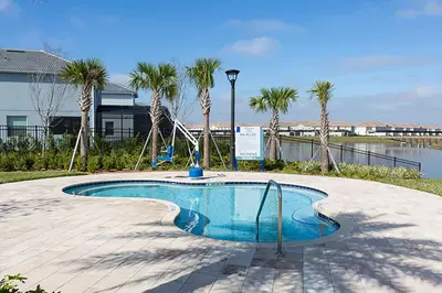a swimming pool with palm trees and a swing at Storey Lake 10BR Home Pool/SPA/Game Room,GreenView in Kissimmee