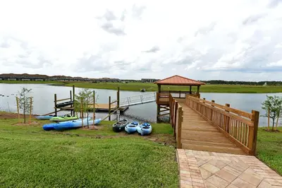 a dock with a bunch of boats on the water at Storey Lake 10BR Home Pool/SPA/Game Room,GreenView in Kissimmee