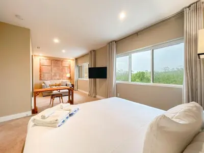 a bedroom with a large white bed and a desk at 3059 Luxury And Relaxation Just 1 Mile From Disney in Orlando