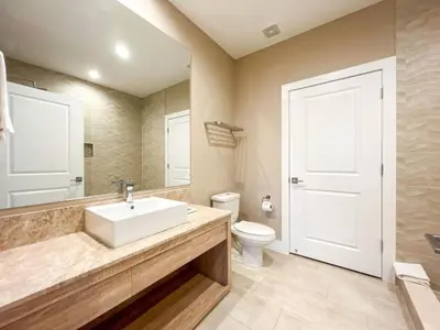a bathroom with a white sink and a toilet at 3059 Luxury And Relaxation Just 1 Mile From Disney in Orlando