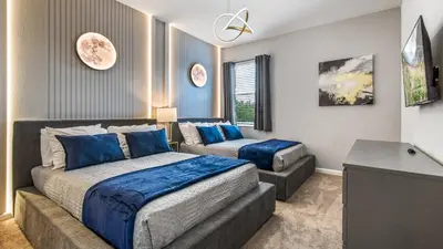 a bedroom with a bed and a couch at Luxury Home: Pool, Theater, Near Disney in Kissimmee