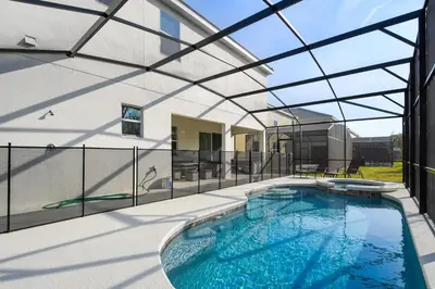 an indoor swimming pool with a glass roof at Mario 12BR Villa w/ Private Green View Pool in Kissimmee