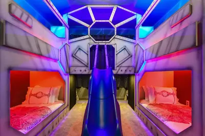 a room with two beds and a slide at Mario 12BR Villa w/ Private Green View Pool in Kissimmee
