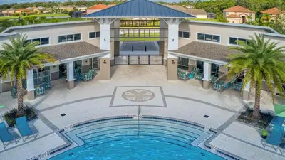 an overhead view of a swimming pool in front of a building at Mario 12BR Villa w/ Private Green View Pool in Kissimmee
