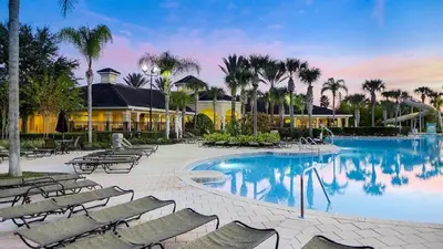 a swimming pool with lounge chairs and a resort at Cozy 6br Home w/ Private Pool Spa in Windsor Hills in Orlando