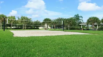 a volleyball net in the middle of a field at Cozy 6br Home w/ Private Pool Spa in Windsor Hills in Orlando