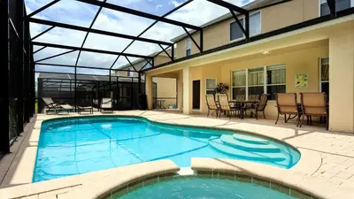 a large swimming pool in a house with a patio at Cozy 6br Home w/ Private Pool Spa in Windsor Hills in Orlando