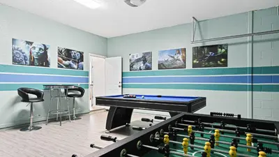 a room with a pool table and some pictures at No Rear Neighbor 6BR Private Pool/Spa Near Disney in Orlando