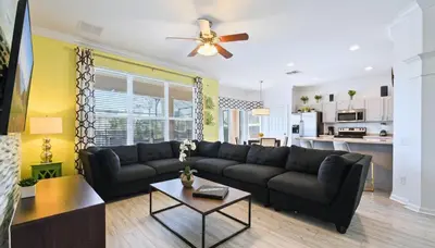 a living room with a couch and a table at No Rear Neighbor 6BR Private Pool/Spa Near Disney in Orlando