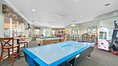 a room with a pool table and arcade games at No Rear Neighbor 6BR Private Pool/Spa Near Disney in Orlando