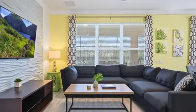 a living room with a couch and a table at No Rear Neighbor 6BR Private Pool/Spa Near Disney in Orlando