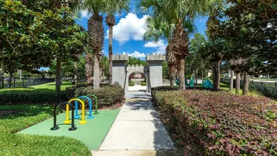 a playground in a park with palm trees at Windsor Hills 6BR Villa Pool/SPA Close to Disney in Orlando