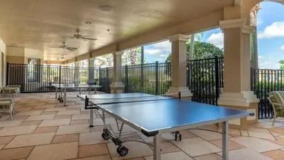 a tennis court with two ping pong tables on a balcony at Highland View 6BR Villa Private Pool Near Disney in Orlando