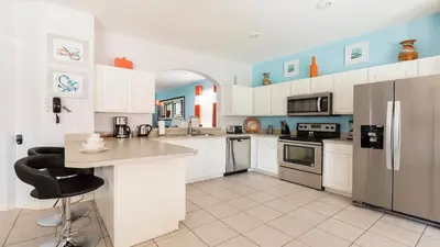 a kitchen with white cabinets and a counter top at Windsor Hill 6BR South-facing Pool/Spa Near Disney in Orlando