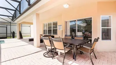 a dining area with a table and chairs at Windsor Hill 6BR South-facing Pool/Spa Near Disney in Orlando