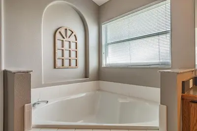 a white bath tub in a bathroom with a window at Santee Villa in Kissimmee