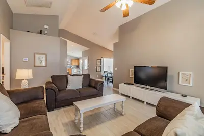 a living room with two couches and a flat screen tv at Santee Villa in Kissimmee