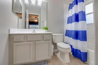 a bathroom with a toilet and a sink and a shower at Emerald Escape in Kissimmee